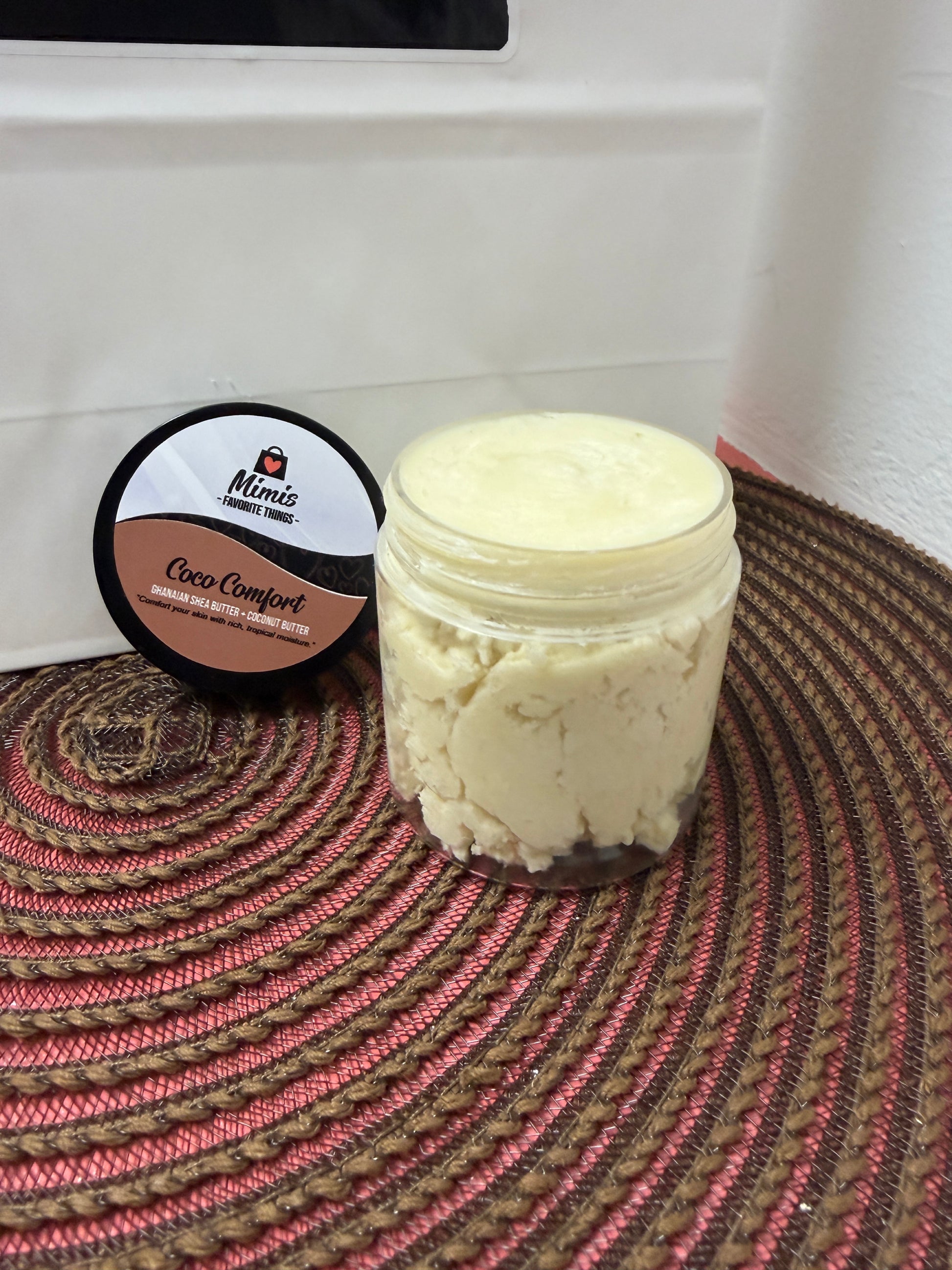 Open jar of Mimi's Favorite Things Coco Comfort Ghanaian shea butter showing handmade texture